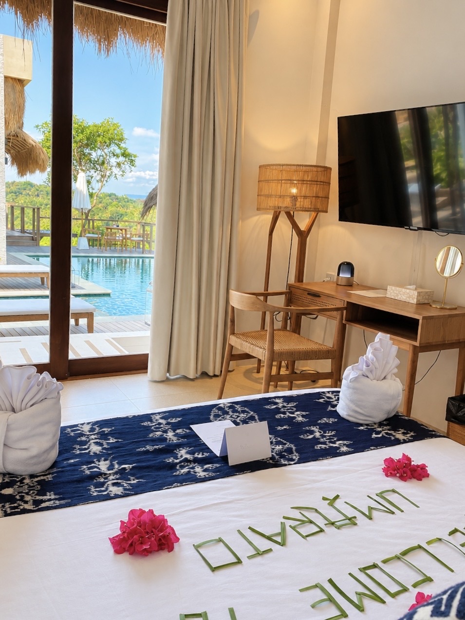Bed prepared with a Umarato welcome flower arrangement