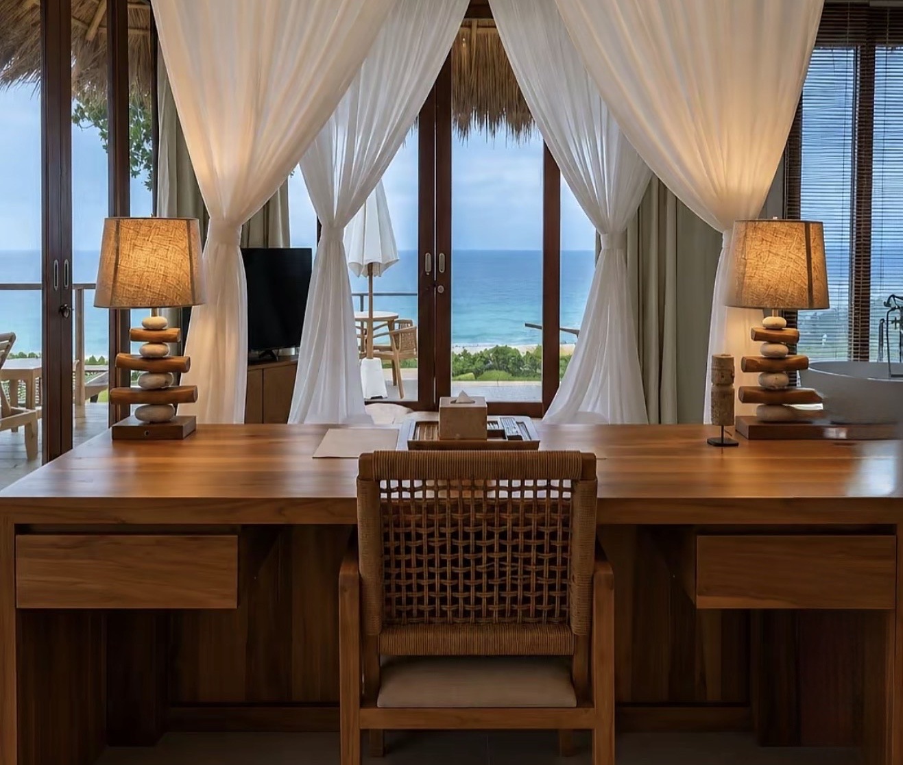 Writing desk with rattan chair and sea view