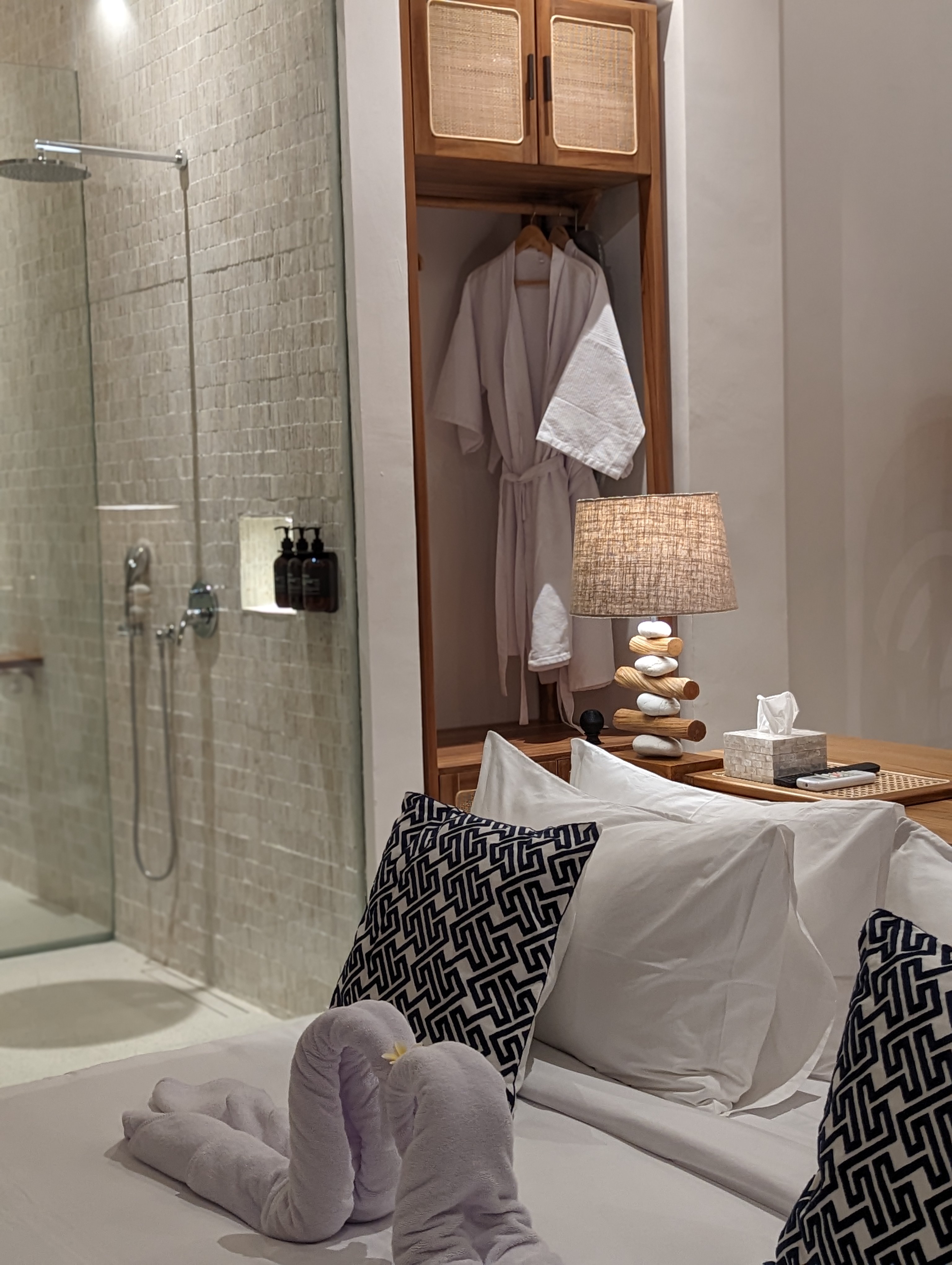 Bedroom with open shower and cane wardrobe