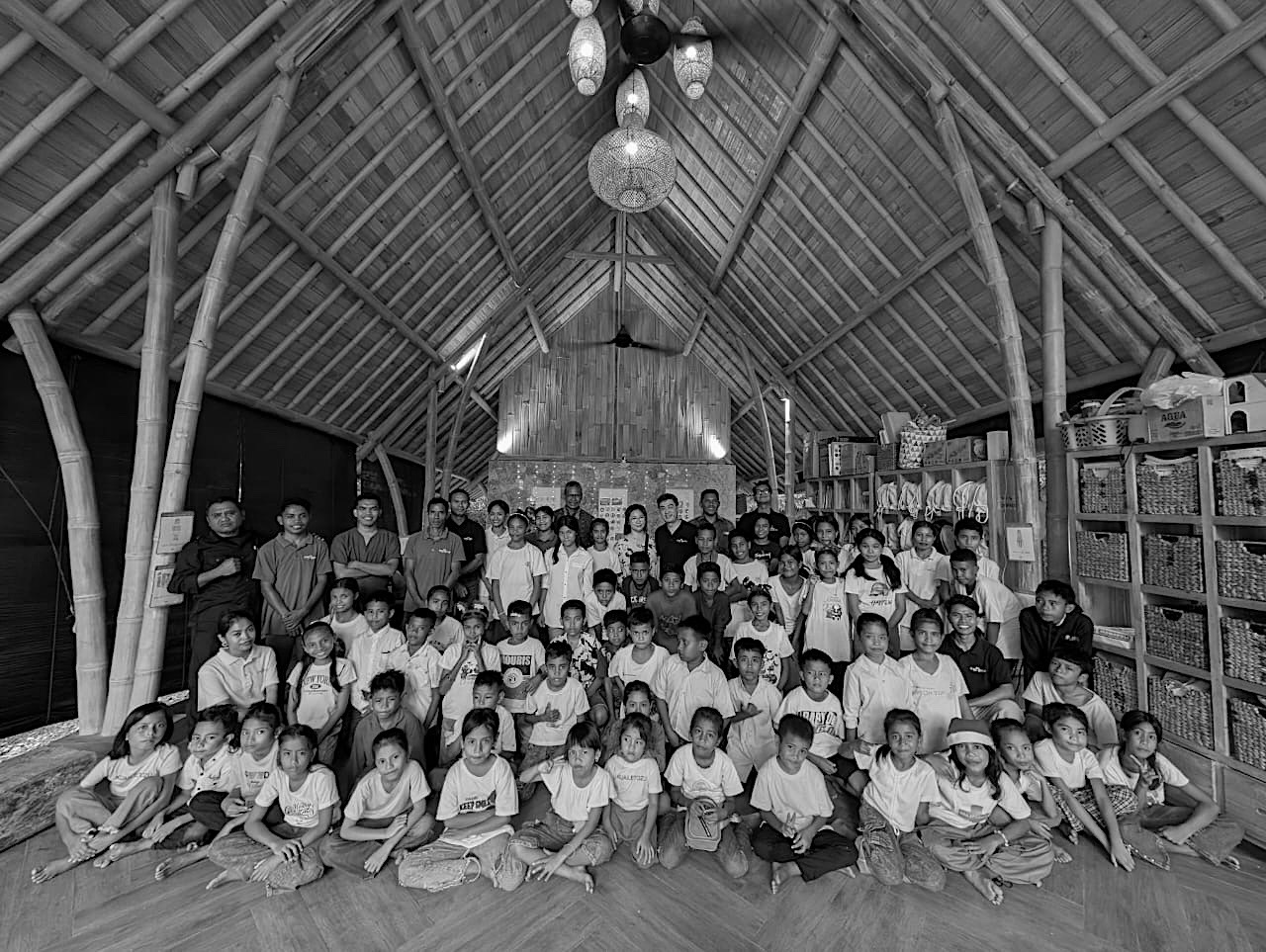 Children and staff gathered inside the bamboo learning center for a Christmas celebration